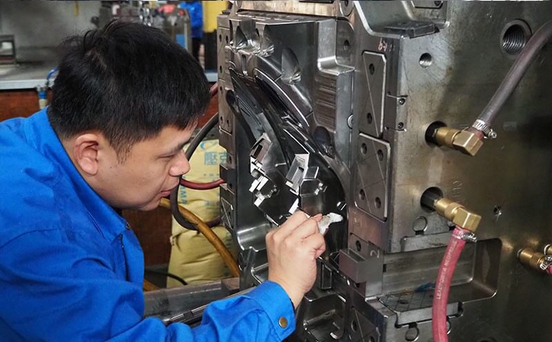 Technician working by hand on a mould cavity